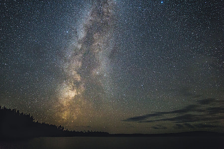 Stars in the night sky over a lake