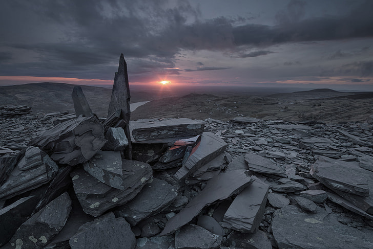 pile of gray rocks during sunset