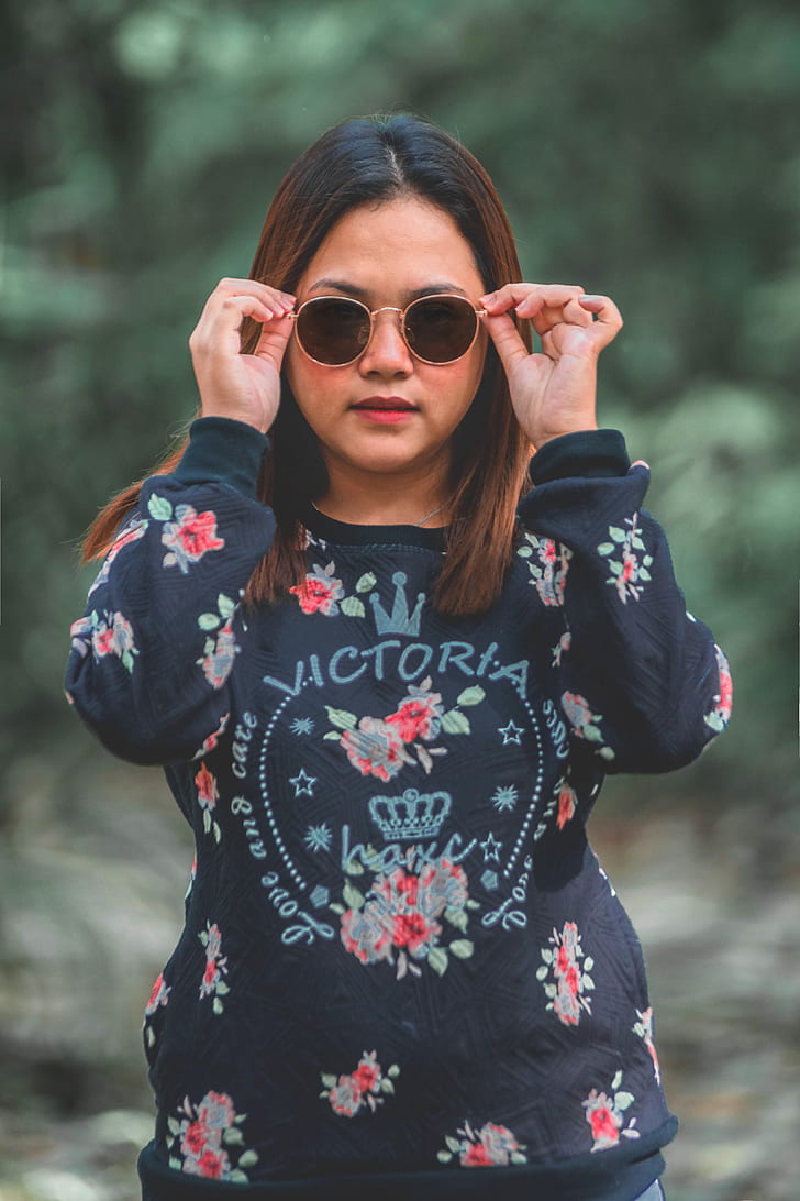 woman wearing black and red floral Victoria long-sleeved shirt
