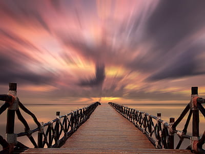 timelapse photo of wooden bridge during golden hour