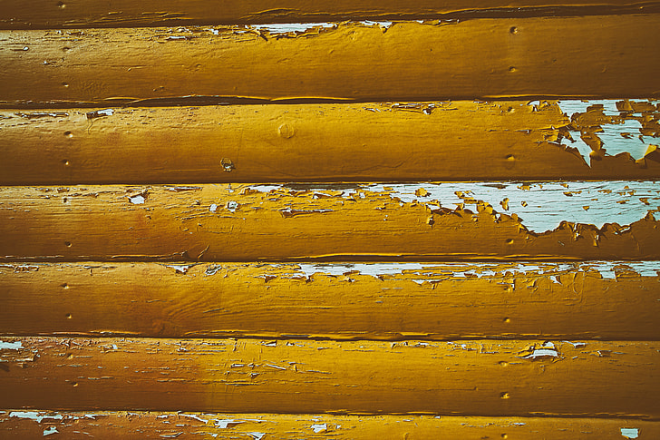 Cracked yellow paint on wood
