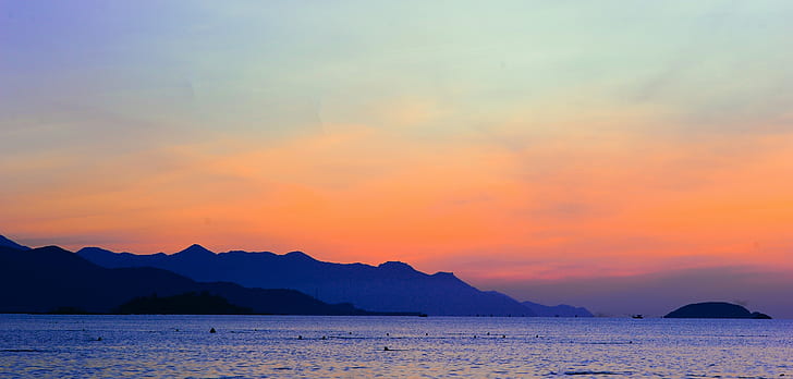 Silhouette of Mountain Beside Ocean during Orange Sunset