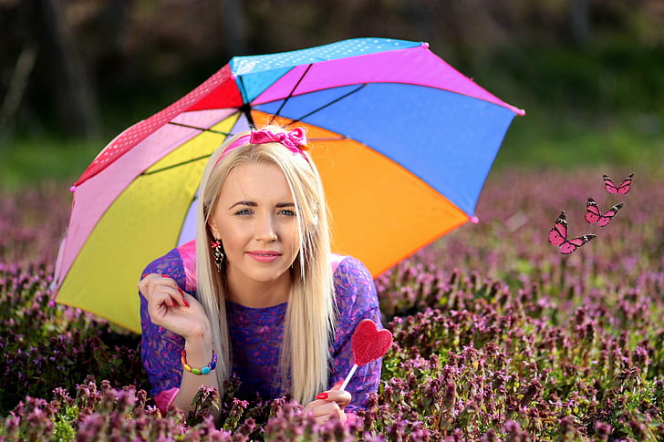 selective focus photography of woman wearing purple dress holding umbrella