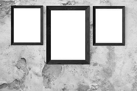 three rectangular photo frames on grey pavement