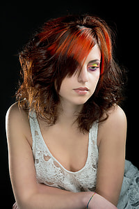 red-haired woman wearing white lace tank top with makeup