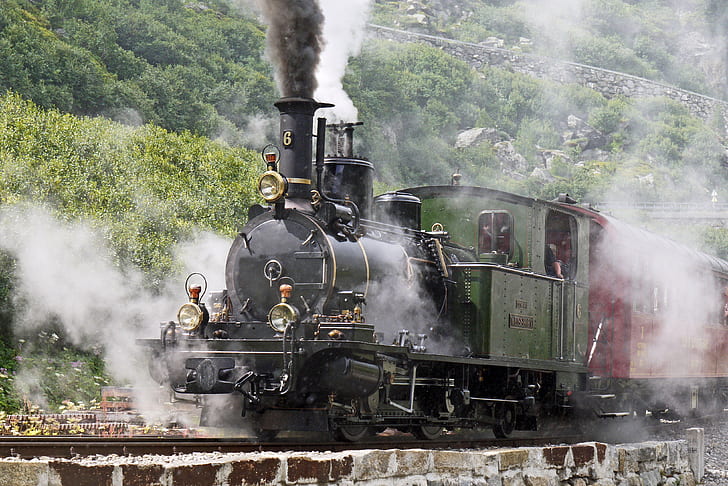 black, green, and red steam train