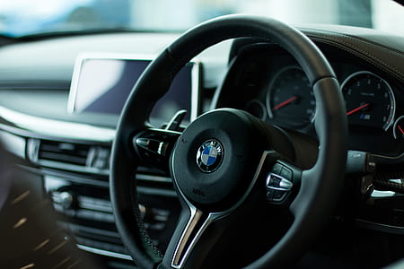 shallow focus photography of black BMW steering wheel
