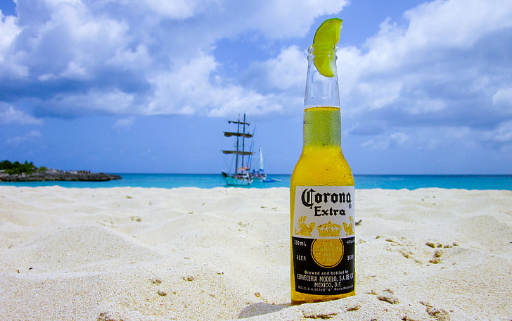 Corona Extra beer bottle at the shore during daytime