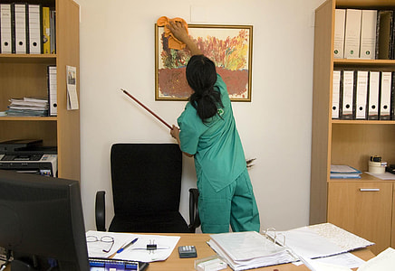 woman cleaning painting inside office