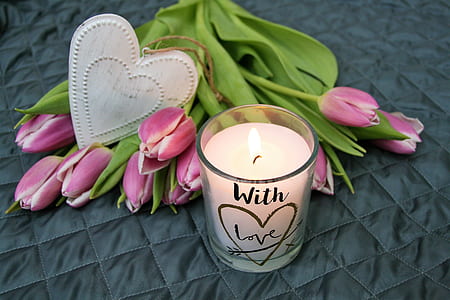 white candle with pink flowers