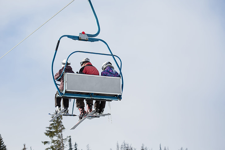 Three Skiers on Ski Lift