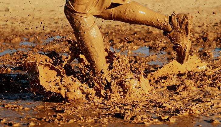 person on mud during daytime