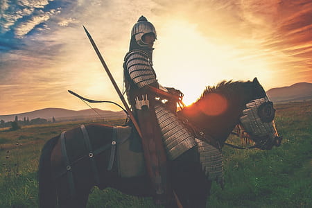 man riding horse during golden hour