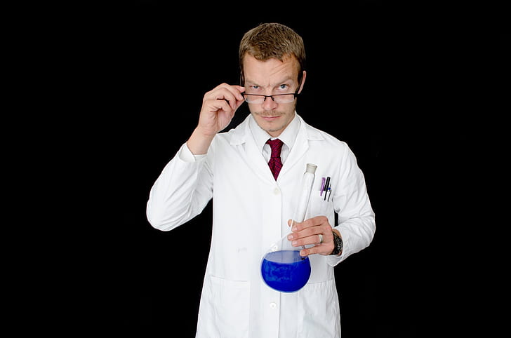 man wearing laboratory gown and eyeglsses