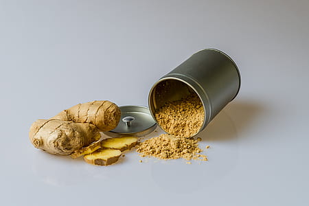 two while gingers beside gray container with powder