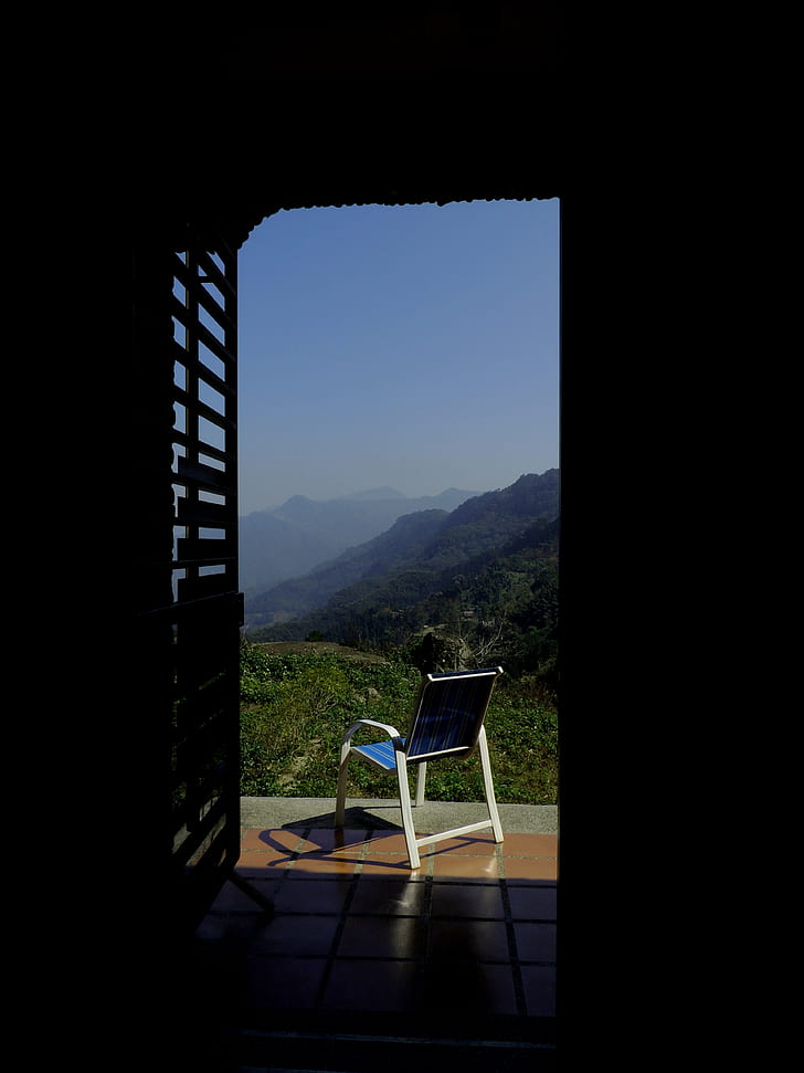 Blue and White Empty Armchair during Daytime Outside With Mountain Range Under Blue Sky during Daytime