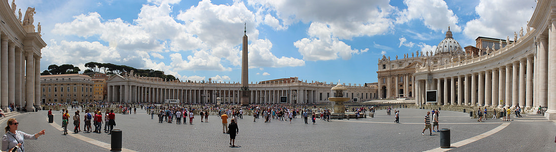 panoramic photo of buildings with monument in between