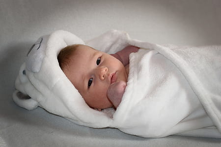 baby with white blanket
