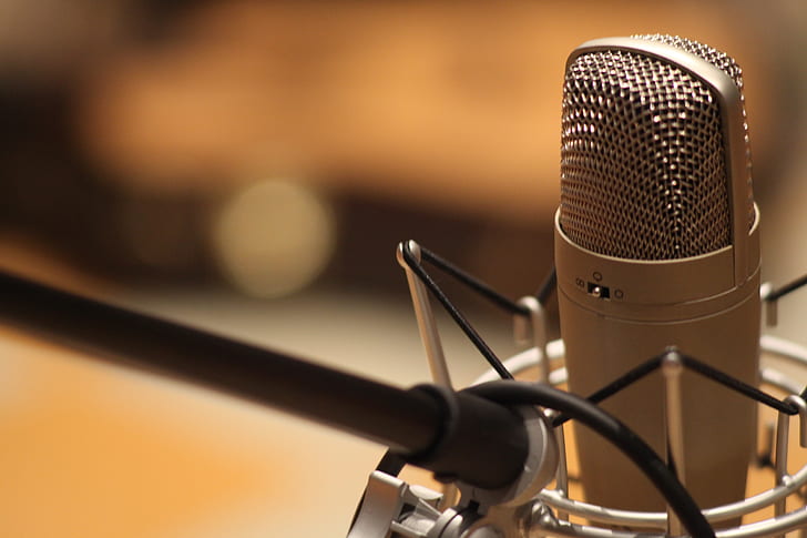selective focus photography of silver condenser microphone