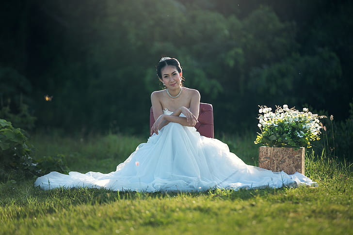 woman in white wedding dress sitting on seat