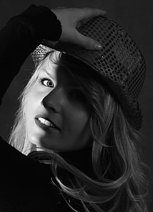 grayscale photography of woman in black fedora hat