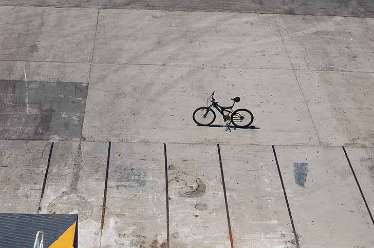 black full-suspension bike on concrete ground