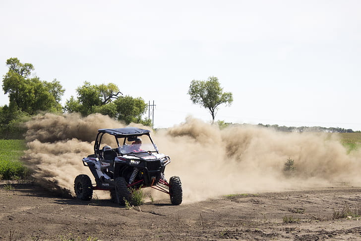 person riding dune buggy during daytime