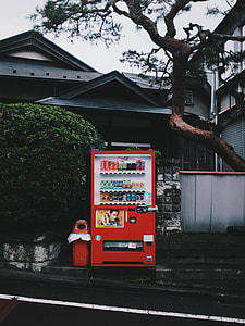 red vending machine in front of house during daytime
