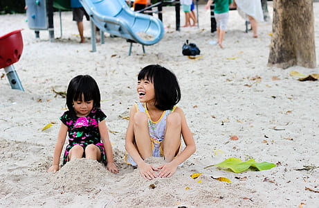 2 Girls Sitting on Seashore