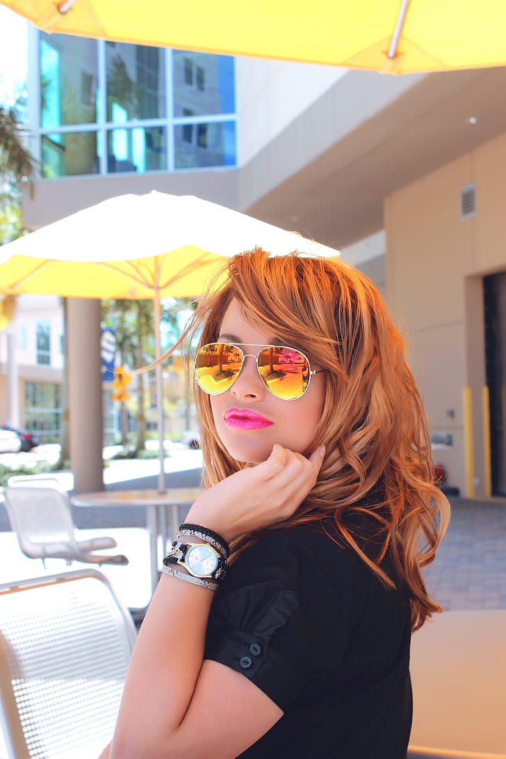 shallow focus photography of orange haired woman wearing aviator sunglasses