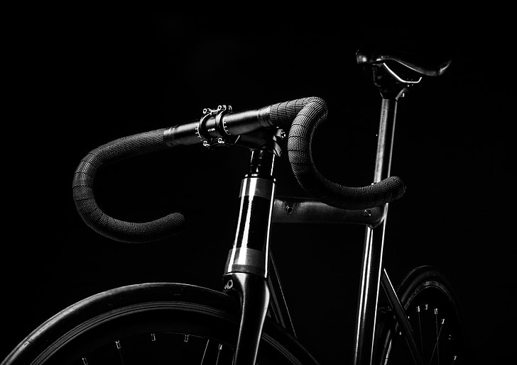 grey scale photography of road bicycle with black background
