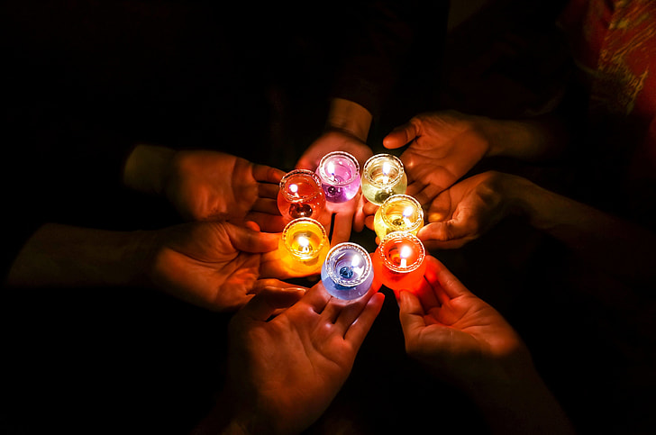 person's holding seven assorted-color candles