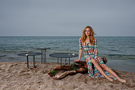 woman in multicolored long-sleeved dress in seashore during daytime