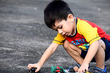 boy playing with toy cars