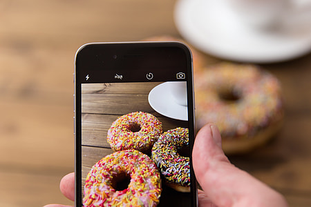 Donuts being captured with the camera of an iPhone mobile smartphone