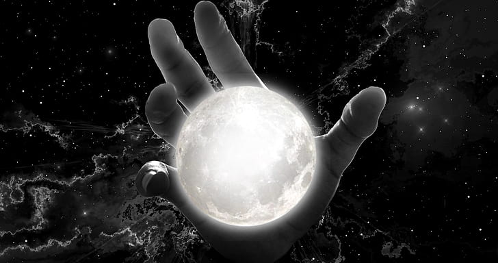 human hand holding moon