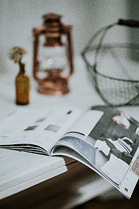 Magazine with a paraffin lamp on a white table