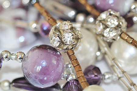 beaded silver-colored, brown, and purple accessory close-up photo