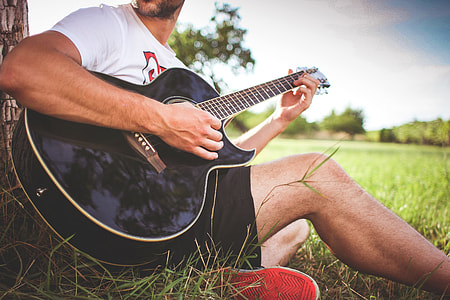 Guy Playing Acoustic Guitar in Nature