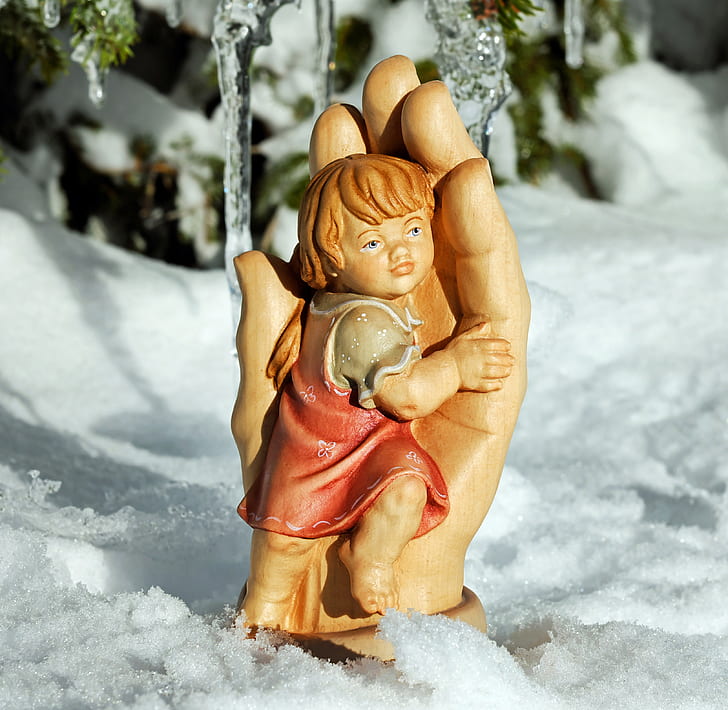 child hugging on hand figurine