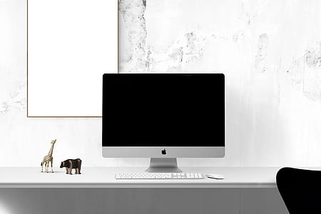 silver iMac on table