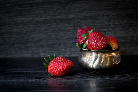 red strawberry fruit in silver bowl in shallow focus photography