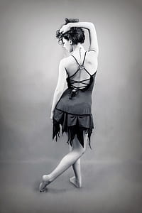 grayscale photo of a woman in backless dress posing for a photo