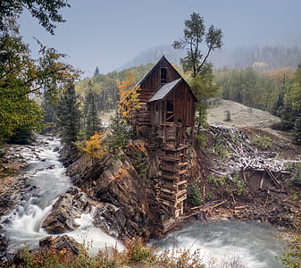 brown wooden cabin on cliff