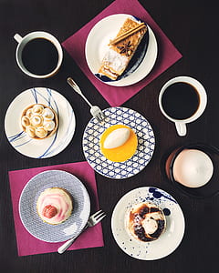 high angle photography of five pastries on top of plate beside two mugs