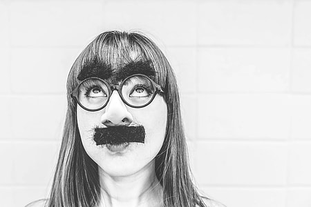 gray scale photo of woman wearing eyeglasses and mustache
