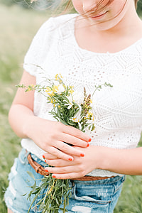 woman holding daisies