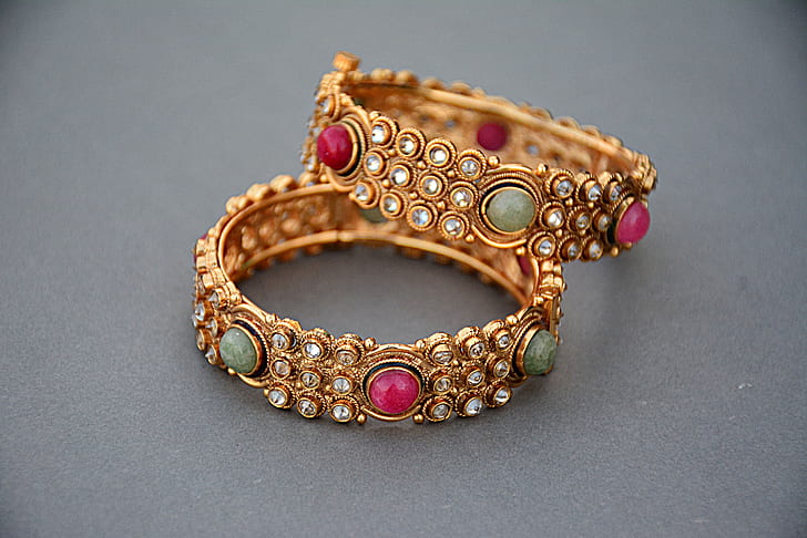 two gold-colored bracelets