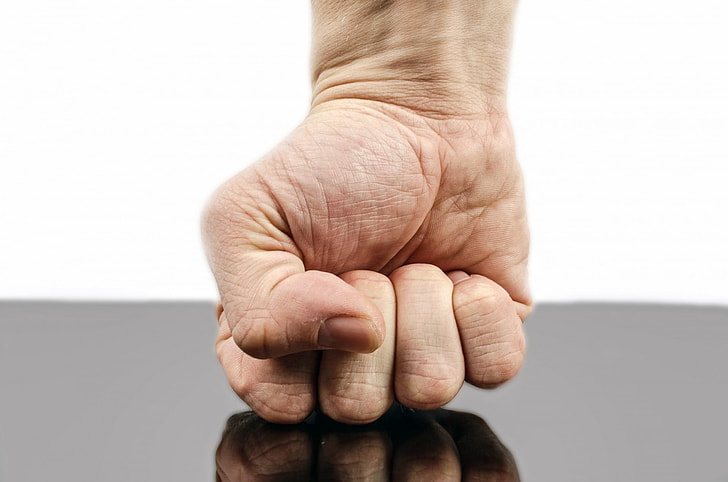 person's right fist on black surface