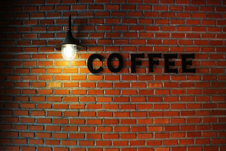 coffee signage on brown concrete wall blocks